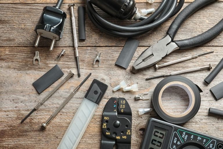 A collection of various tools, such as hammers and saws, laid out on a wooden table for easy access and organization.